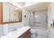 Bright bathroom featuring a vanity with storage, a mirrored medicine cabinet, and a tiled tub with shower at 6 Escondido Cir # 55, Altamonte Springs, FL 32701