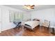 Bedroom with wood flooring, a ceiling fan, large window, and a comfortable bed and chairs at 6 Escondido Cir # 55, Altamonte Springs, FL 32701