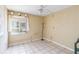 Bedroom featuring tile flooring, a ceiling fan, and a window with natural light at 6 Escondido Cir # 55, Altamonte Springs, FL 32701