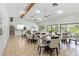 Community clubhouse featuring a dining area, tile floors, and large windows overlooking the pool at 6 Escondido Cir # 55, Altamonte Springs, FL 32701