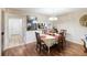 Cozy dining area featuring wood floors, an elegant chandelier, and views into the kitchen at 6 Escondido Cir # 55, Altamonte Springs, FL 32701