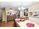 Charming dining room with wood floors and a unique view of the kitchen at 6 Escondido Cir # 55, Altamonte Springs, FL 32701