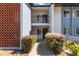 Close-up of the condo entrance featuring dual doors, a concrete walkway, and mature shrubs at 6 Escondido Cir # 55, Altamonte Springs, FL 32701