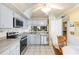 Bright kitchen featuring stainless steel appliances, white cabinetry, and tiled backsplash at 6 Escondido Cir # 55, Altamonte Springs, FL 32701