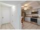 Bright kitchen with stainless steel appliances, tiled floor, and a view into the dining area at 6 Escondido Cir # 55, Altamonte Springs, FL 32701