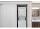 Laundry closet with a stacked washer and dryer unit, located next to the bathroom at 6 Escondido Cir # 55, Altamonte Springs, FL 32701