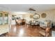 Spacious living room and dining area with hardwood flooring, decorative mirrors, and cozy seating at 6 Escondido Cir # 55, Altamonte Springs, FL 32701