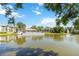 A picturesque community view across the pond featuring a fountain and surrounding lush greenery at 6 Escondido Cir # 55, Altamonte Springs, FL 32701