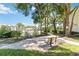 Relaxing walking path with a bench surrounded by beautiful trees and landscaping overlooking the lake at 6 Escondido Cir # 55, Altamonte Springs, FL 32701