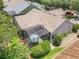 An aerial view showcases the home's screened-in patio, landscaping, and a well-maintained shingle roof at 600 Garden Club Dr, Deland, FL 32724