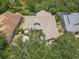 Birds eye view of home with neutral color palette, brick roof, and mature trees at 600 Garden Club Dr, Deland, FL 32724
