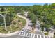 Aerial view of a quiet intersection in a lush green community with mature trees on a sunny day at 600 Garden Club Dr, Deland, FL 32724