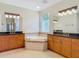 Spacious bathroom with double vanities, granite countertops, and a large soaking tub at 600 Garden Club Dr, Deland, FL 32724