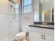 Bathroom features a glass shower, toilet, vanity, sink with dark granite countertop, and a mirror at 600 Garden Club Dr, Deland, FL 32724
