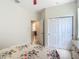 Light and airy bedroom with tile floors and arched entry to the kitchen at 600 Garden Club Dr, Deland, FL 32724
