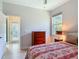 Bedroom with a ceiling fan, closet, and large bed with colorful floral design at 600 Garden Club Dr, Deland, FL 32724