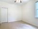 Bright bedroom with tile flooring, closet, and natural light from the window at 600 Garden Club Dr, Deland, FL 32724