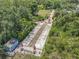 Overhead view showing the bocce ball and putting green area surrounded by lush trees at 600 Garden Club Dr, Deland, FL 32724