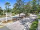 Scenic view of winding road leading into the Bay Forest at Pelican Landing community entrance with lush trees at 600 Garden Club Dr, Deland, FL 32724