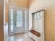 Bright foyer features tiled floor, decorative glass door, and convenient hall tree at 600 Garden Club Dr, Deland, FL 32724