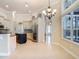 Large kitchen with island and eat-in nook filled with natural light, connecting to the living room at 600 Garden Club Dr, Deland, FL 32724
