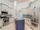 Gourmet kitchen with stainless steel appliances, island, and custom cabinets at 600 Garden Club Dr, Deland, FL 32724