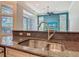 Close-up of the kitchen sink with granite countertops, overlooking the living room and backyard at 600 Garden Club Dr, Deland, FL 32724