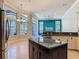 Bright, spacious kitchen with island, stainless appliances, view to living room, and outdoor patio at 600 Garden Club Dr, Deland, FL 32724