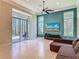 Bright living room with a wall of windows and view of outdoor patio, featuring a modern ceiling fan at 600 Garden Club Dr, Deland, FL 32724