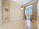 Open-concept living space features tiled floors and access to the back patio at 600 Garden Club Dr, Deland, FL 32724