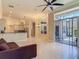 Bright open-concept living room features tiled floors and sliding glass doors to the lanai at 600 Garden Club Dr, Deland, FL 32724