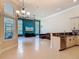 Open-concept living space with a kitchen island, large windows, and a sleek entertainment setup at 600 Garden Club Dr, Deland, FL 32724