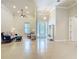 Bright living room featuring elegant decor, tiled floors, and decorative glass on the front door at 600 Garden Club Dr, Deland, FL 32724