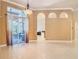 Spacious and bright living room features tiled flooring, arched doorways, and access to the patio at 600 Garden Club Dr, Deland, FL 32724