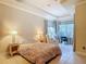 Bright main bedroom with tray ceiling, tile floor, sitting area, and lots of natural light at 600 Garden Club Dr, Deland, FL 32724