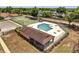 Community pool area with fencing, tennis court, and ample lounging space, perfect for recreation at 6017 Brookhill Ct, Orlando, FL 32810