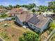Aerial view of a residential home featuring solar panels, well-kept yard, and a patio at 6017 Brookhill Ct, Orlando, FL 32810