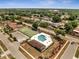 A birds-eye view of community pool and tennis courts surrounded by houses and lush greenery at 6017 Brookhill Ct, Orlando, FL 32810