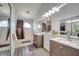 Bright bathroom with double sinks, vanity, tub, and shower featuring modern fixtures and ample counter space at 6017 Brookhill Ct, Orlando, FL 32810