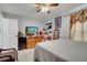 Functional bedroom featuring a ceiling fan, tile flooring, and a comfortable bed, offering a cozy retreat at 6017 Brookhill Ct, Orlando, FL 32810