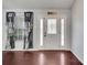 Inviting entryway featuring a decorative glass door, sidelights, dark hardwood floors, and elegant curtains at 6017 Brookhill Ct, Orlando, FL 32810