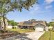 Charming single-story home with a well-manicured lawn, solar panels, and a welcoming driveway at 6017 Brookhill Ct, Orlando, FL 32810