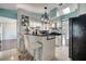 Modern kitchen featuring stainless steel appliances, dark countertops, white cabinets, and a breakfast bar at 6017 Brookhill Ct, Orlando, FL 32810
