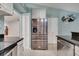 Modern kitchen featuring stainless steel appliances, dark countertops, white cabinets, and access to the dining room at 6017 Brookhill Ct, Orlando, FL 32810