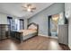 Comfortable main bedroom featuring dark wood floors, a ceiling fan, and neutral gray walls at 6017 Brookhill Ct, Orlando, FL 32810
