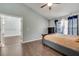 Comfortable main bedroom featuring dark wood floors, a ceiling fan, neutral gray walls, and ample natural light at 6017 Brookhill Ct, Orlando, FL 32810