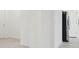 Hallway leading to kitchen with tile flooring and stainless steel refrigerator at 6139 Claystone Way, Mount Dora, FL 32757