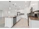Spacious kitchen with a large island, stainless steel appliances, and a mosaic tile backsplash at 6139 Claystone Way, Mount Dora, FL 32757
