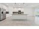 Modern kitchen featuring an island, stainless steel appliances, and white cabinets at 6139 Claystone Way, Mount Dora, FL 32757