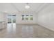 Bright living area with tile flooring, natural light, and sliding door access at 6139 Claystone Way, Mount Dora, FL 32757